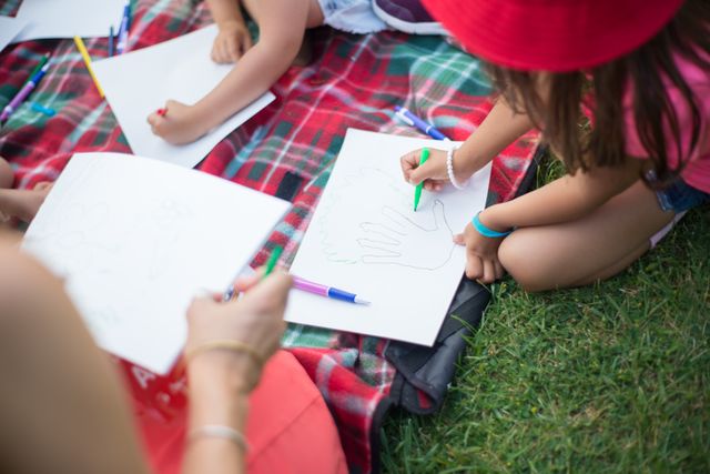 pexels-photo-8954827-8954827 Kids engaging in creative activities on a picnic blanket outdoors during daytime in Portugal.